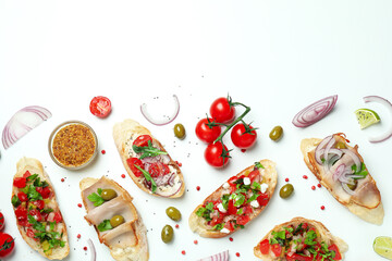 Delicious italian snacks bruschetta and ingredients on white background