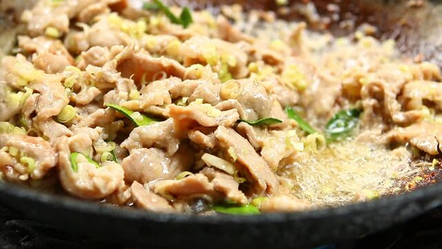 Fried chopped pork with chopped lemon grass and kaffir leaves  in pan , Thai famous food