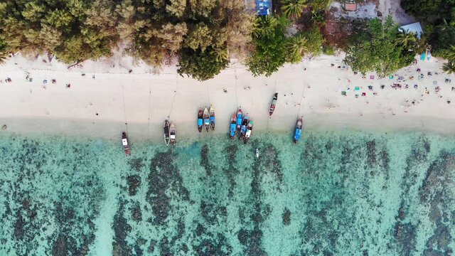 Wooden long-tail boat with coral reef in tropical sea at lipe island