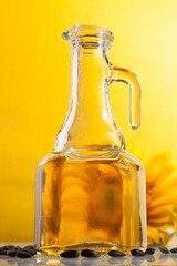 Sunflower oil in a transparent jug with sunflower flower