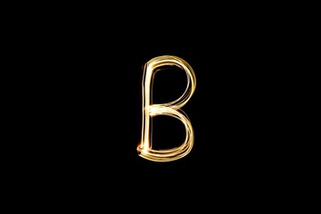 Drawn letter B with gold lights against black background. Light painting alphabet.