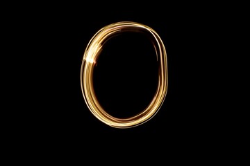 Drawn letter O with gold lights against black background. Light painting alphabet.