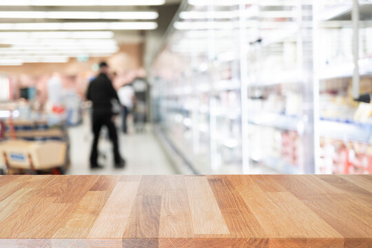 Table Top With Abstract Blur Beautiful Luxury Shelf Food  Store In The Shopping Mall And Blurred Light Interior Background With Bokeh Department Store, Ready For Product Montage.