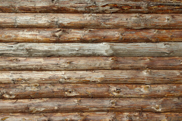 Old wooden log wall of a house. Close-up. Background. Texture.