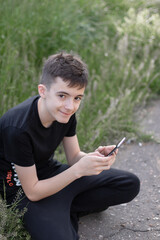Teenage boy using mobile phone.
