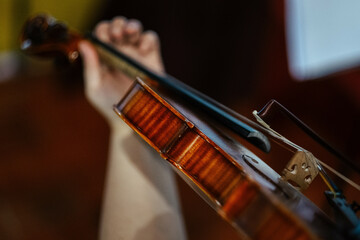 Closeup of a violinist playing violin at the concert, focus on the violin