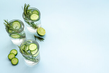 Cold fresh cocktail with lemon slices cucumber and rosemary