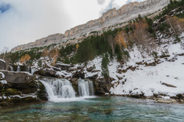 River waterfall in a valley in a mountain river landscape in snowy winter, with trees in Ordesa Valley, Pyrenees, national park, Spain.
Horizontal view