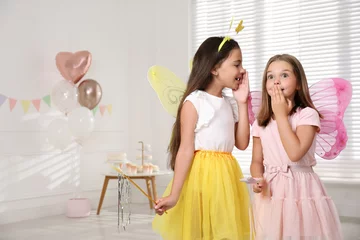 Fotobehang Cute little girls wearing fairy costumes in decorated room. Space for text © New Africa