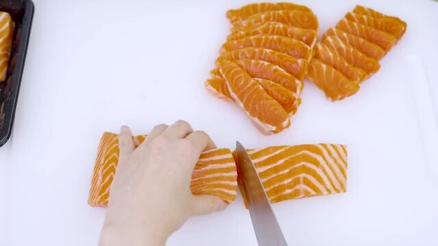 Top view - home cooking cutting salmon preparing for sashimi and for preserved in shoyu.