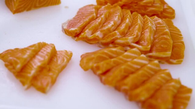 Closeup - home cooking cutting salmon preparing for sashimi and for preserved in shoyu.