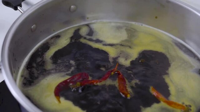 Boiling black soup with dry chili