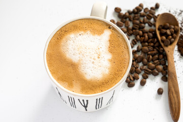 hot latte and coffee beans on white background