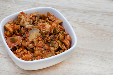 Achar made of green mango on rustic table with copy space