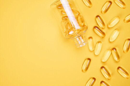Omega 3 capsules.Vitamin drop pill capsule. Shining golden essence droplet.	
