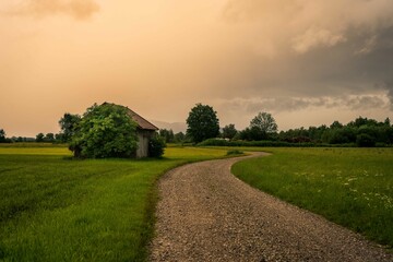 Meadow with path in the Allgäu before a thunderstorm