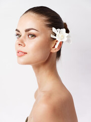 Fototapeta premium attractive woman with bare shoulders bright makeup white flower in hair