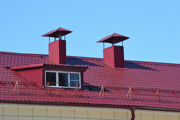 chimney on the roof of the house against the blue sky