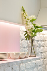 flowers in vase on shelf 