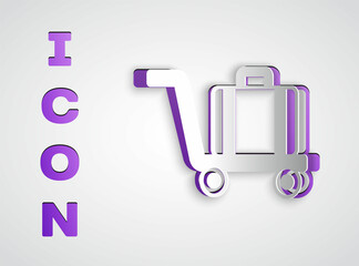 Paper cut Trolley suitcase icon isolated on grey background. Traveling baggage sign. Travel luggage icon. Paper art style. Vector