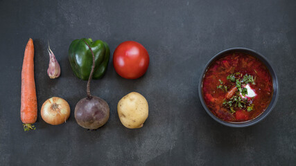 Russian borsch in a bowl and vegetables top view  . Black key boscht . Russian and ukrainian food . 