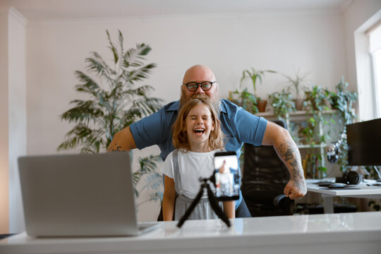 Laughing Daughter With Funny Daddy Pose Together Shooting New Video For Blog At Home