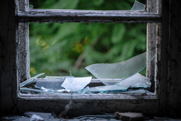 Smashed glass Window with old wooden frame. old window. finely broken glass. old house, retro. cracked window frame. cracked old paint, pieces of glass. close-up, space for text