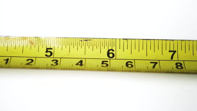 Yellow tape measure on a white background 
