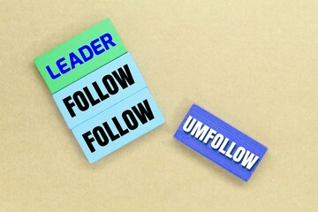 colored boards with the words follow leader and unfollow