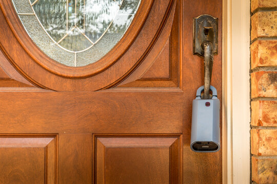 Lockbox For Realtors On A Door At A For Sale Listed House