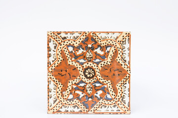 authentic patterned, handmade ceramic tile. original. White background. Selevtive Focus. Isolated.