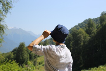 Happy mature woman standing in the mountain and enjoying the view.