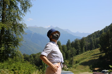 Mature woman wearing face mask at the nature in the mountains.