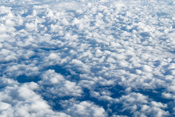 View of the sky above the clouds. blue sky high view from airplane window clouds shapes. sky-clouds background. Above the cloud
