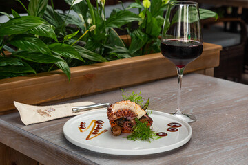 grilled octopus with a glass of red wine