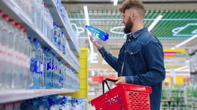 Man buying mineral water in the shop