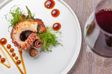 grilled octopus with a glass of red wine