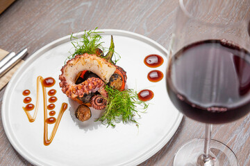 grilled octopus with a glass of red wine