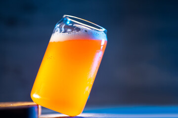 A stylish glass of craft beer on a dark blue background. Indian pale ale copy space