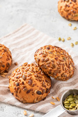 Gluten-free bread from corn flour and seeds close-up. Homemade bread with pumpkin and sunflower seeds. Breakfast buns. Free space for text