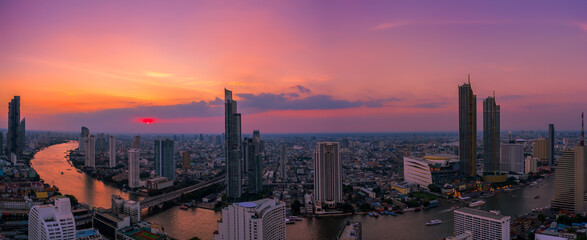 Twilight cityscape of famous downtown with Chao Phraya river in Bangkok Thailand