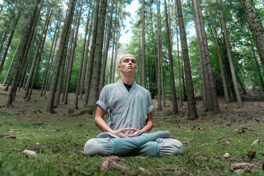 Warrior monk meditating in woodland