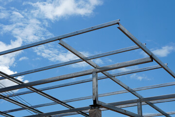 Connecting steel roof trusses to concrete columns. Modern style steel roof.