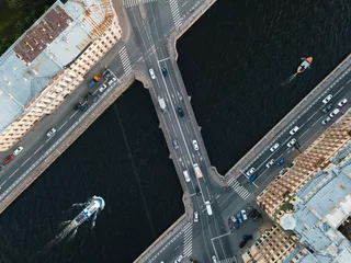 Gardinen Brücken View from above on Ismaylovsky bridge across Fontanka river. Blurred car motion on bridge. A pleasure boat is floating on the water. Close up view from above. Historical center of St Petersburg.  © Denis Mamin