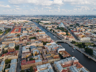 Obraz premium Aerial view of historical center of St Petersburg. Photo of Fontanka river, Trinity Cathedral, Nikolskie ryady and many old living houses. Cloudy blue sky. Russian cities. Place for vacation.