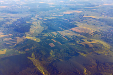 Aerial landscape with green meadows . Countryside view from the plane window 