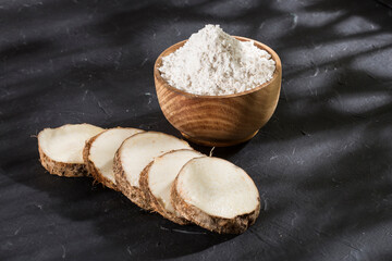Taro Root of Colocasia esculenta and Organic Taro Flour in a bowl