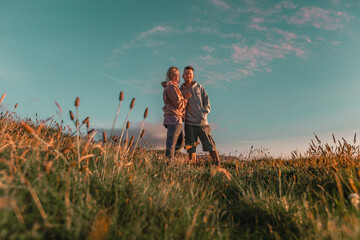 Couple enjoying the sunset in a field