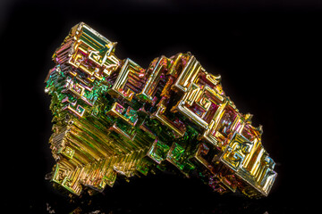 Macro of the mineral bismuth stone on a black background