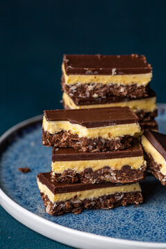 Nanaimo bars - a traditional Canadian dessert - on a dark background